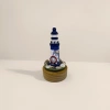 Blue and white striped lighthouse model, wooden base, nautical theme decoration, including rudder, shell and fishing net Application Scenario